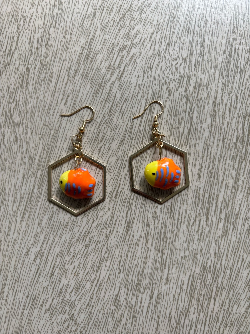 Hand Crafted Gold colored Hexagon Earrings with GlassOrange & Yellow Fish Charms